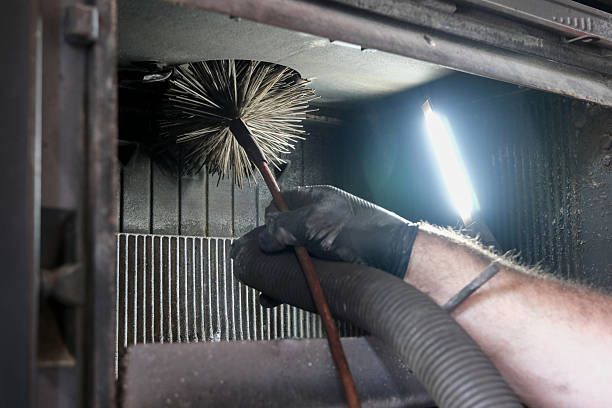 Brush cleaning inside a boiler flue passage in a Brooklyn building