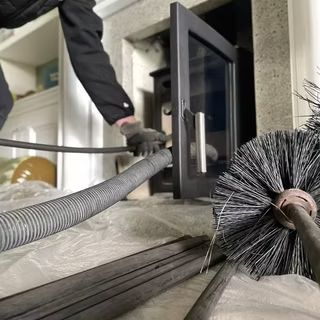Sweep's brush and vacuum hose staged at a Brooklyn hearth